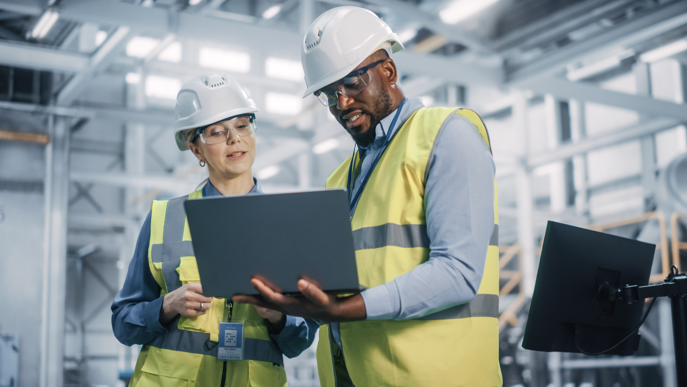 Stock photo of warehouse workers collaborating.