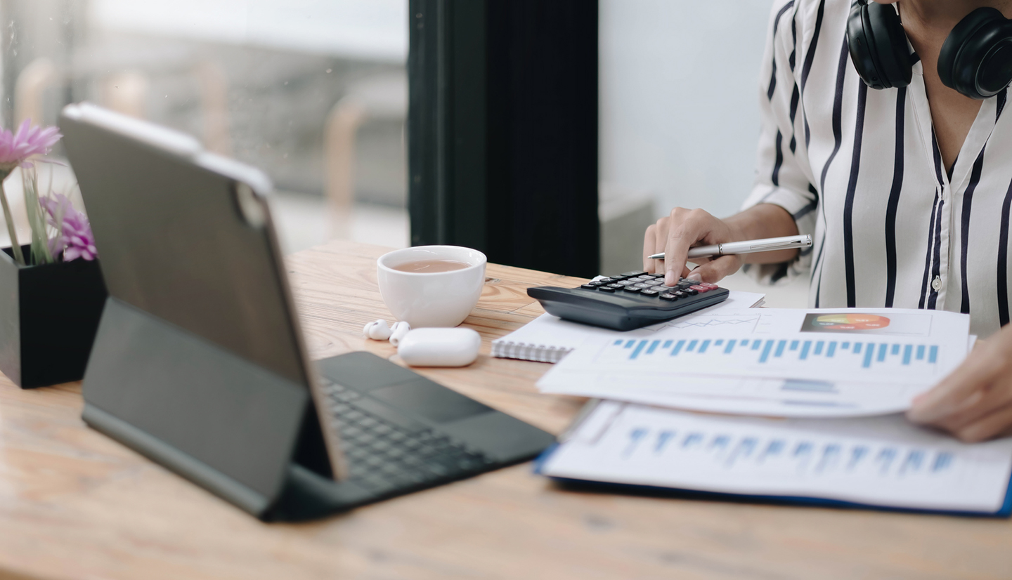 woman calculate financial graphs that show results and analyze financial arrangements for business investment. woman calculate financial graphs that show results and analyze financial arrangements for business investment.