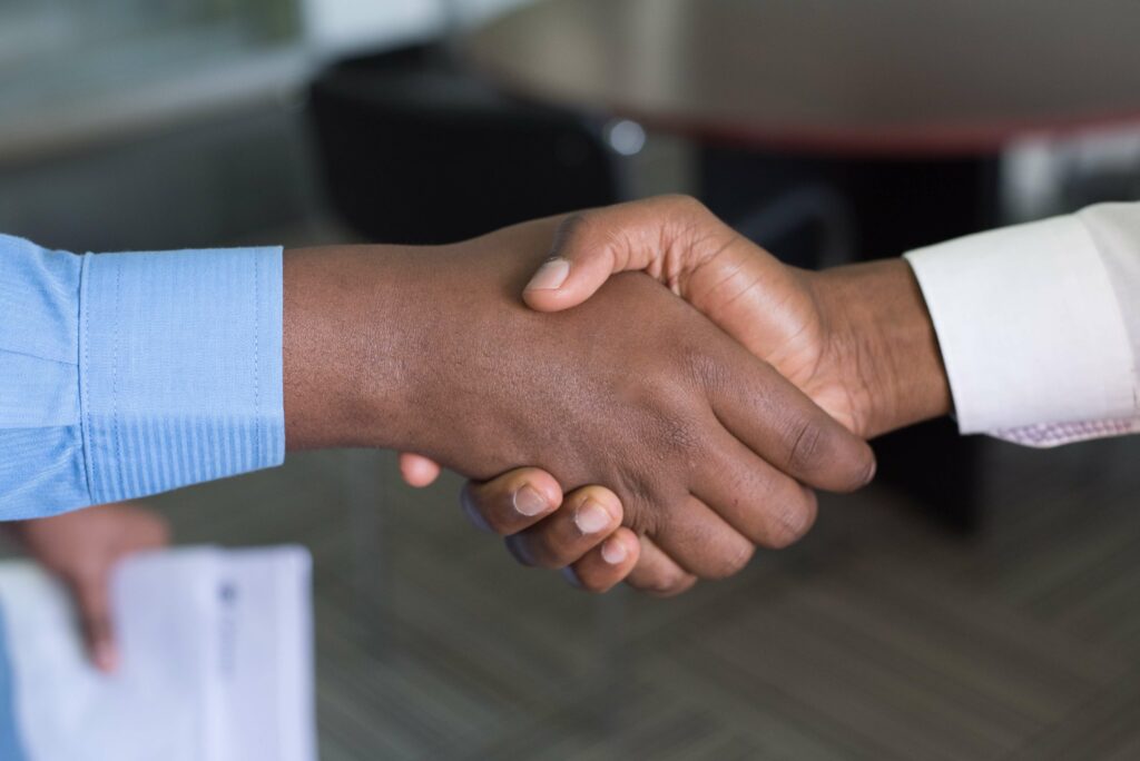 a close-up of two people shaking hands