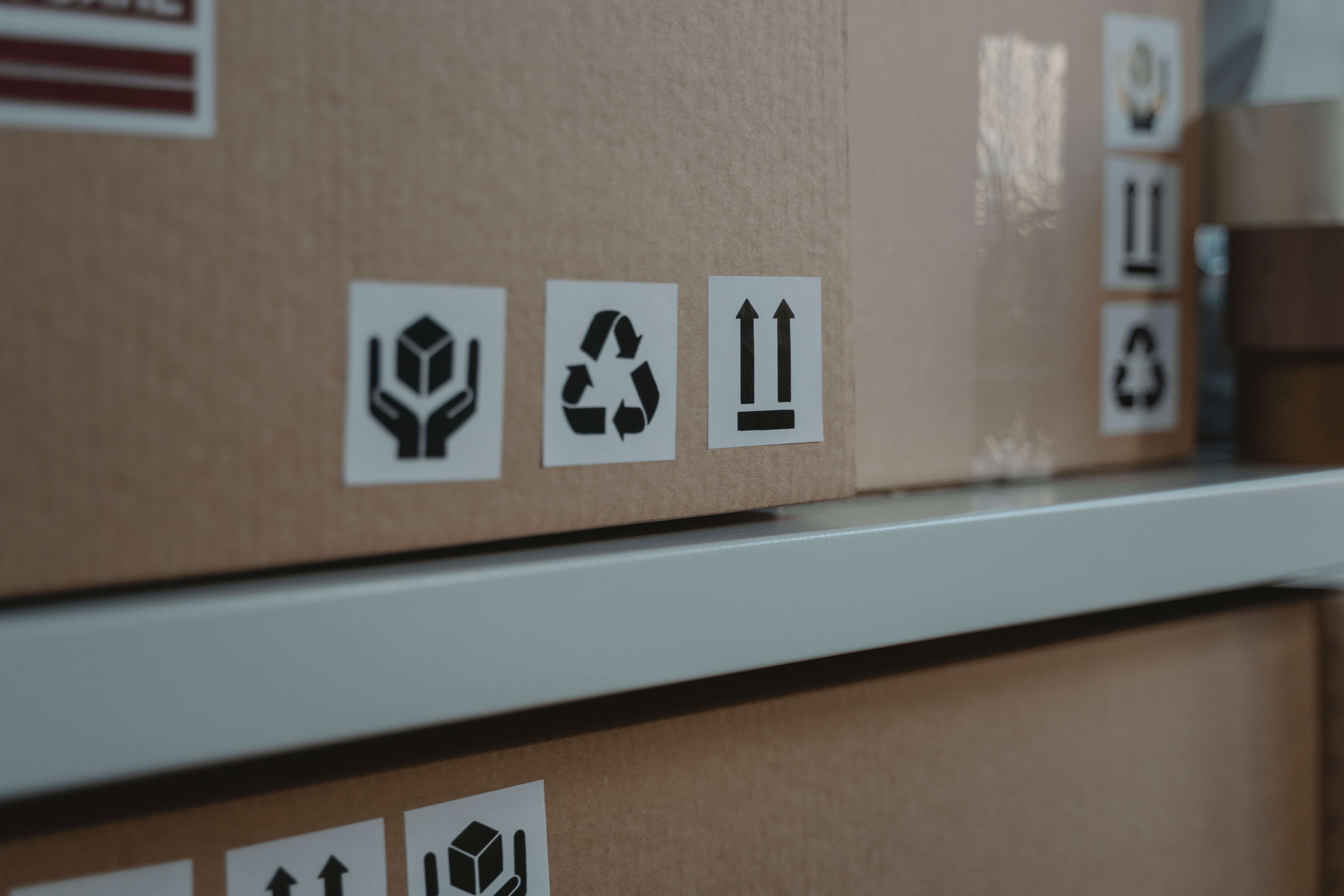 cardboard boxes marked with shipping stickers sit on shelves ready for shipment