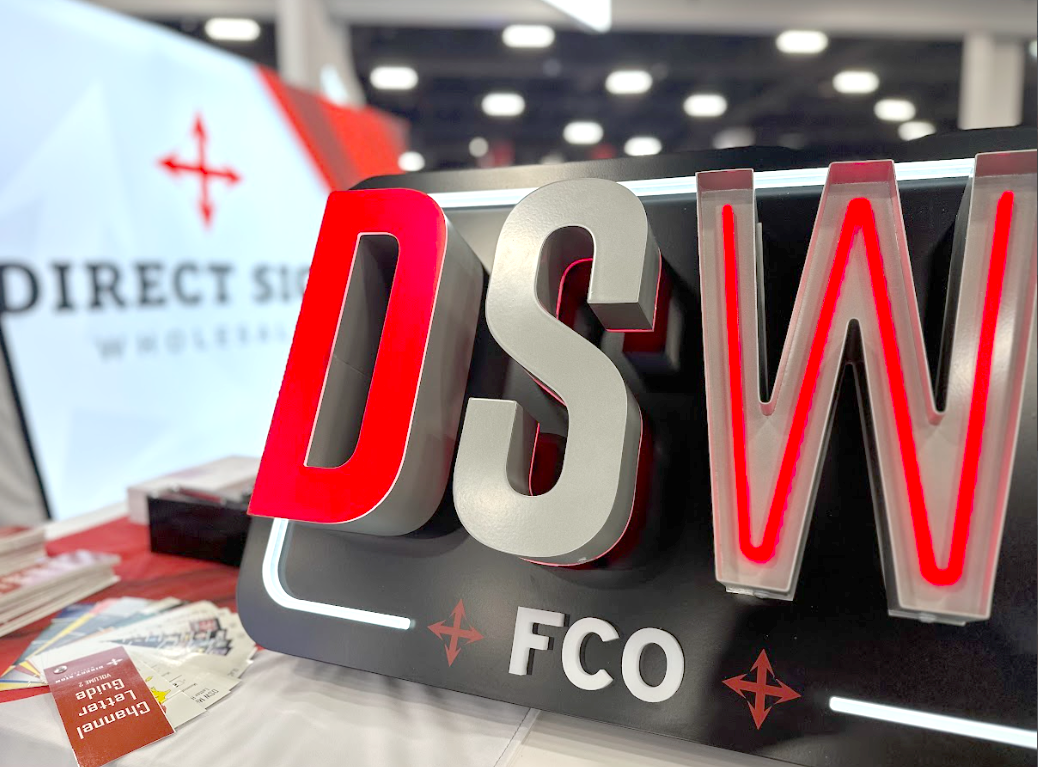 A fabricated sign showcasing a wireway, with front trimless, reverse halo, and push-thru style letters, accented by a push-thru border, FCO letters, and vinyl accents.